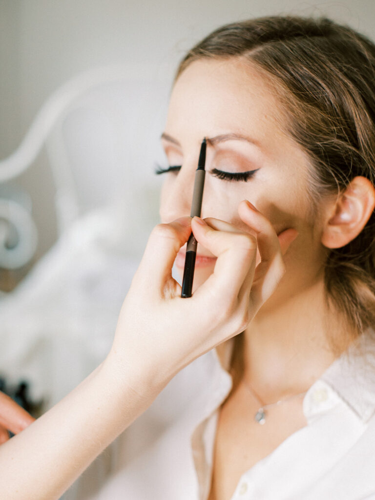 Bridal makeup application in progress by wedding makeup Winnipeg specialist Jessica Kmiec