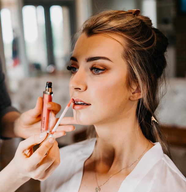Winnipeg bride getting her makeup done on her wedding day.