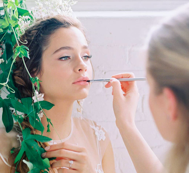 Makeup artist Jessica Kmiec applying long lasting wedding makeup on bride